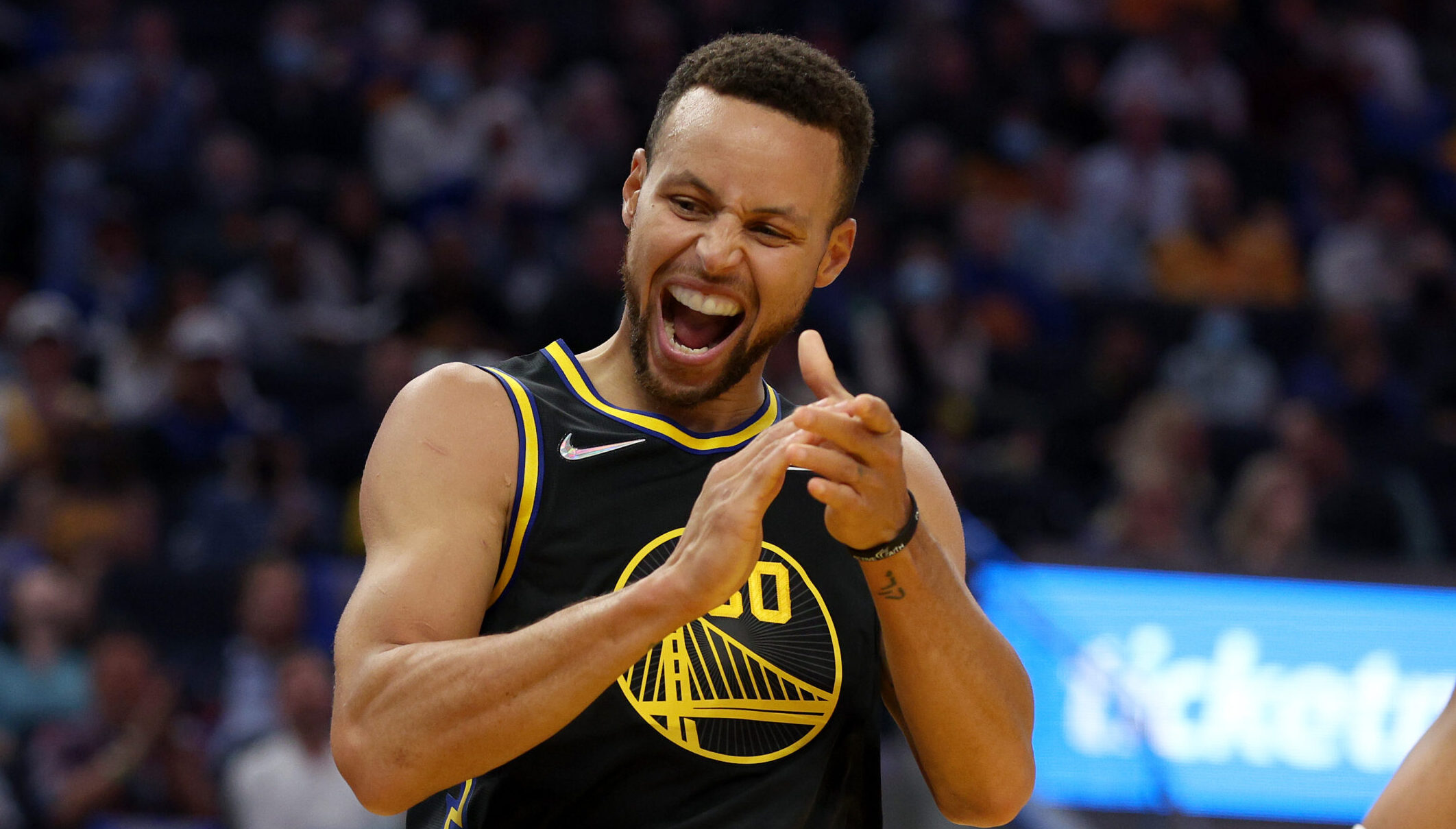 Stephen Curry walks across the stage at Davidson graduation ceremony