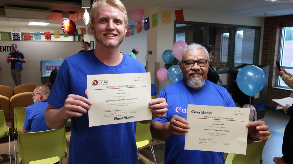 Cliff diver Beau Gentry (L) and longtime Casa Bonita employee Alex Perez (R) show off their certificates.