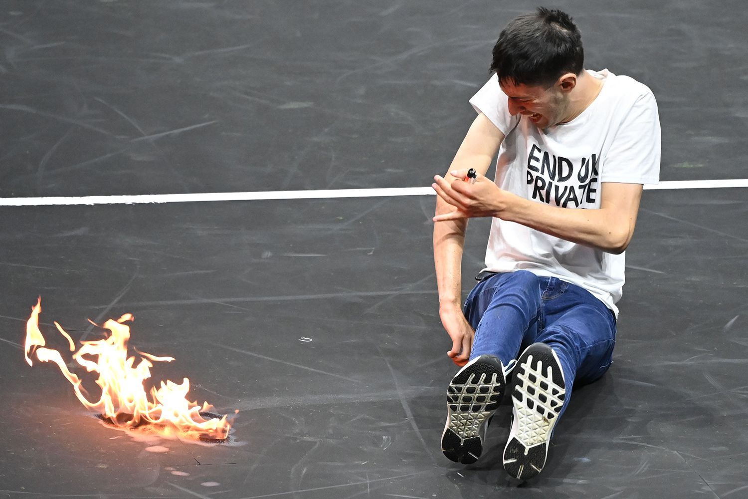 Local weather Protester Units Arm on Hearth at Roger Federer’s Laver Cup