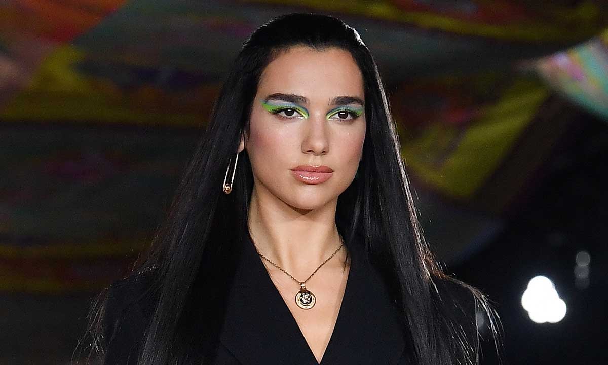 Dua Lipa serves up tropical magic in racy halterneck mini costume