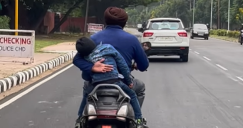 Man Holds Youngster With One Hand Whereas Driving Scooter