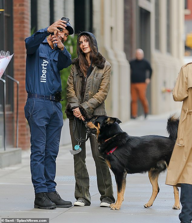 Emily Ratajkowski exhibits off her sense of fashion carrying light denims as she walks her pup Colombo