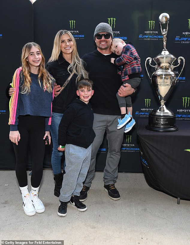 Christina Corridor, her husband Joshua and youngsters attend Monster Power Supercross Movie star Night time