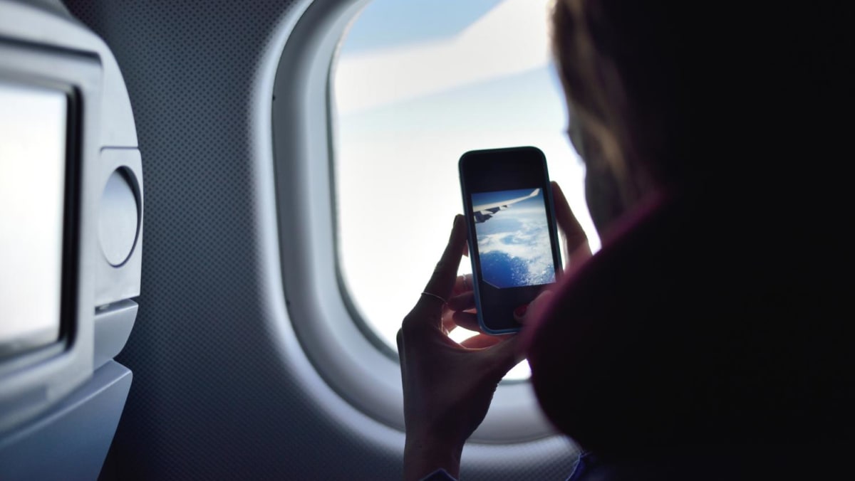 CNA Explains: Do you have to swap off your cellphone whereas on a flight?