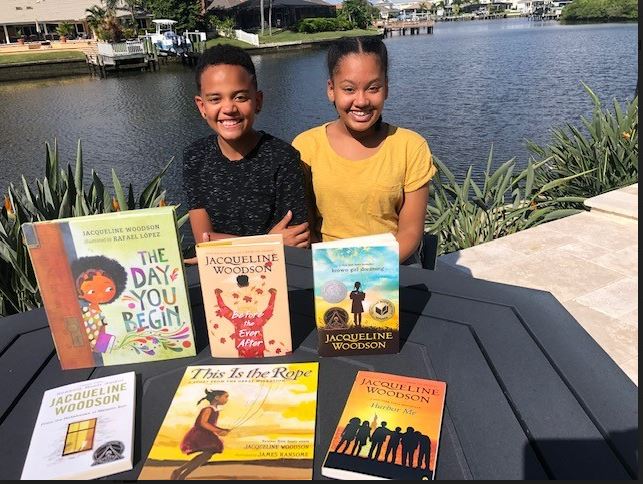 Siblings donate various books to high school